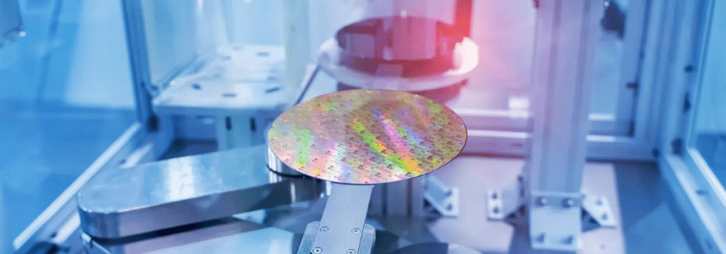 Semiconductor wafers A semiconductor wafer sitting on a pedestal inside a machine with another wafer in the background