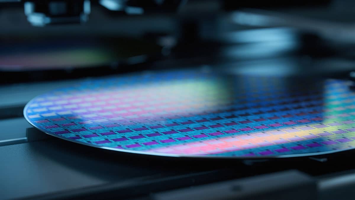 A semiconductor wafer disc at a low angle and several of the chips on the wafer are visible